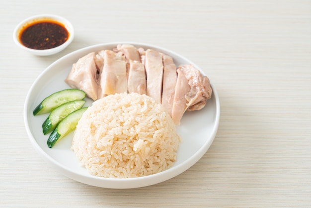 Premium Photo | Hainanese chicken rice or rice steamed with chicken ...