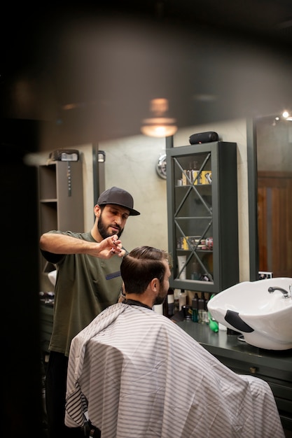 Free Photo | Hairdresser cutting a man's hair at the barber shop