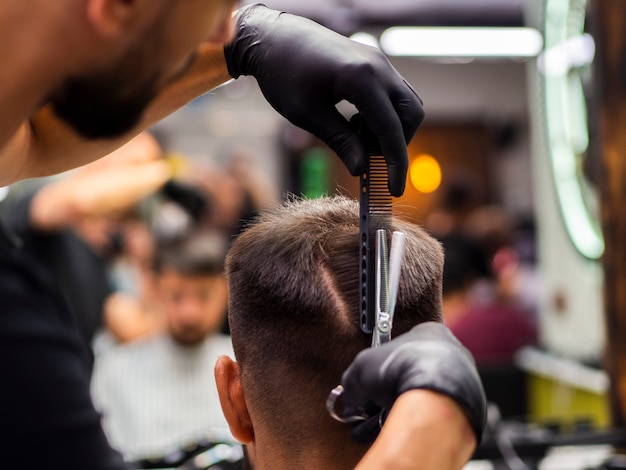 Hairdresser Man Giving A Haircut Free Photo