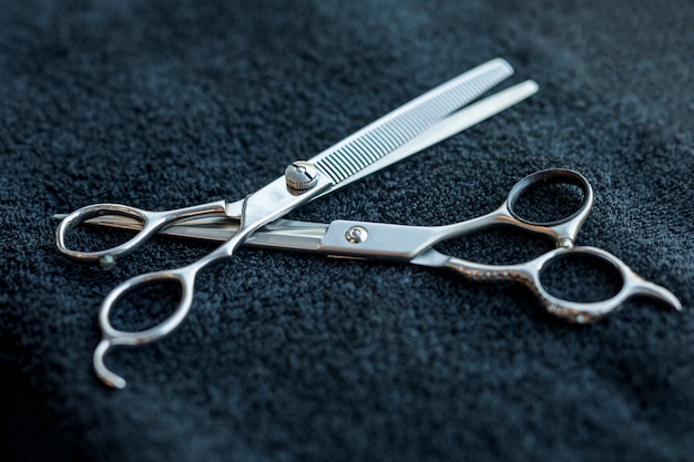 Hairdressers Scissors Lying On Dark Cloth Free Photo