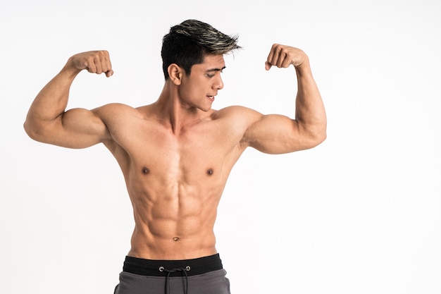 Premium Photo Half Body Image Of Young Man Showing Muscular Biceps Stand Facing Forward