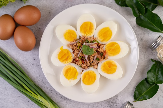 Half boiled egg and pork larb on a plate Free Photo
