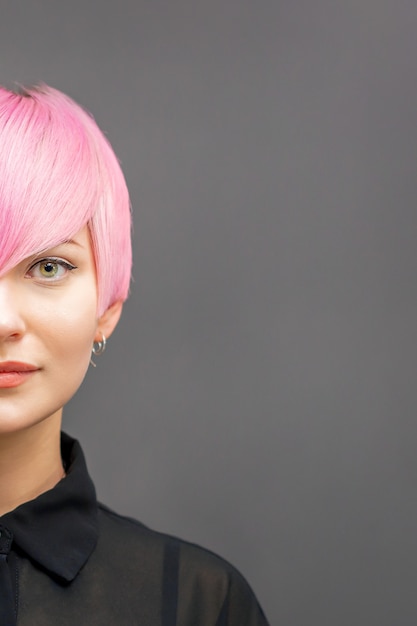 Premium Photo Half Face Portrait Of A Beautiful Young Caucasian Woman With Short Bright Pink Hairstyle