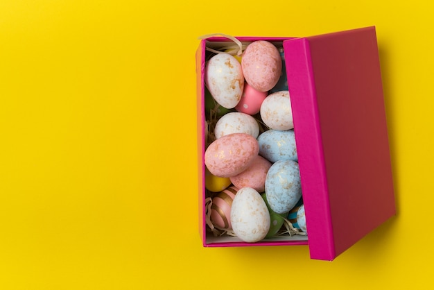 Download Premium Photo Half Open Gift Box With Festive Eggs On Yellow Background Easter Eggs PSD Mockup Templates