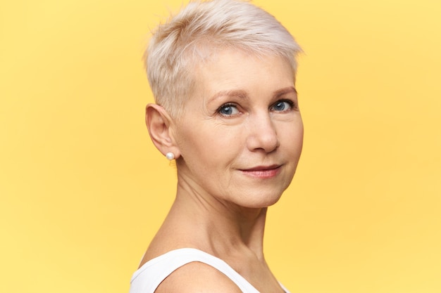 Free Photo Half Profile Shot Of Beautiful Middle Aged European Woman With Blue Eyes Short Dyed Hair And Face Wrinkles Posing In Studio Having Confident Look