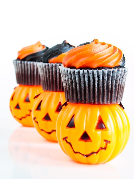 Premium Photo | Halloween cupcakes decorated with black and orange ...