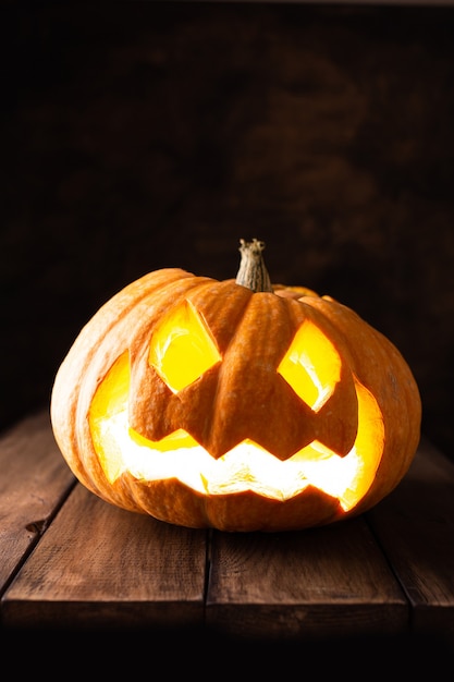 Premium Photo | Halloween lightning pumpkins for party on a wooden table