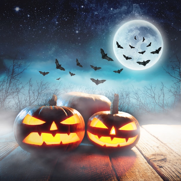 Premium Photo Halloween Pumpkins In A Mystic Forest At Night With