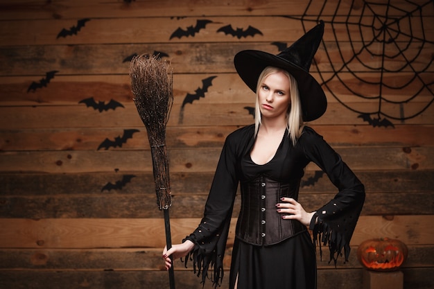 Premium Photo Halloween Witch Concept Happy Halloween Sexy Witch Holding Posing Over Old 8594