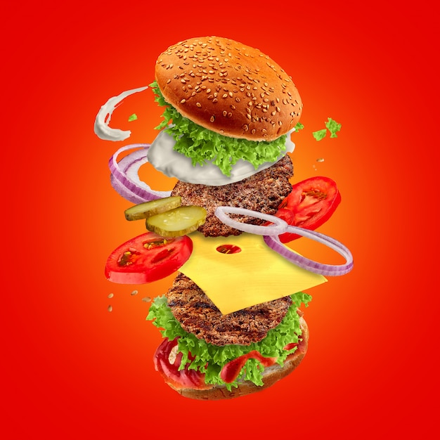 Premium Photo | Hamburger with flying ingredients