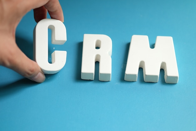 Hand arrange white letters as crm Free Photo