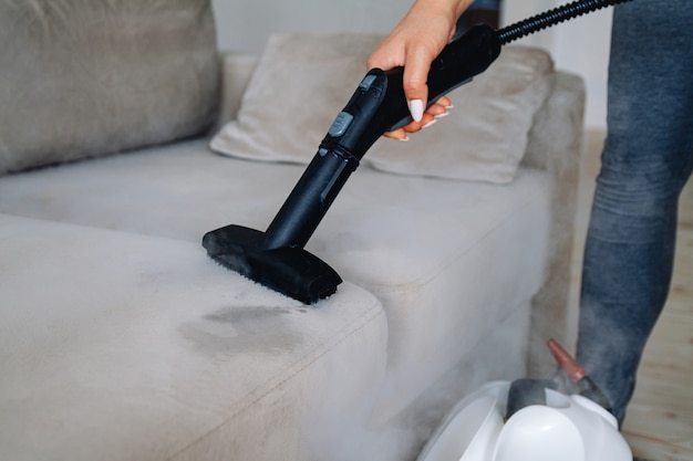premium-photo-hand-cleaning-a-sofa-with-a-steam-cleaner