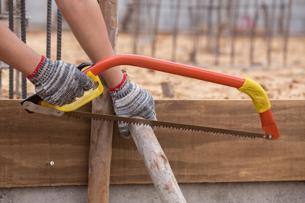 Premium Photo | Hand cutting wood by hand saw