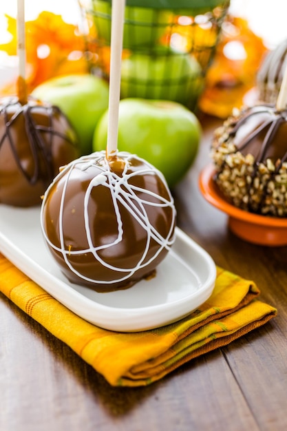 Premium Photo | Hand dipped caramel apples decorated for halloween.