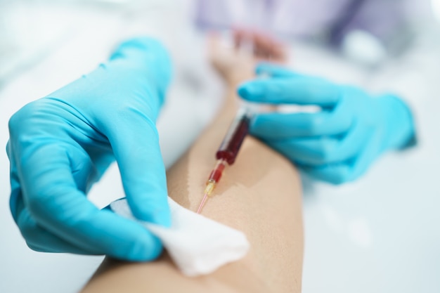 Premium Photo | Hand of doctor in blue gloves taking blood sample from ...