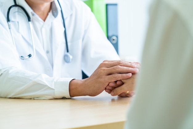 Hand of doctor reassuring her female patient Premium Photo