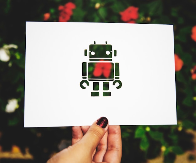 Hand hold robot paper carving with nature background Free Photo