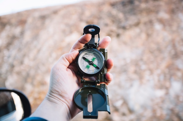 Free Photo | Hand holding compass at hill