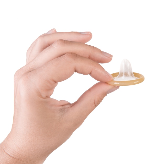 Premium Photo | Hand holding a condom isolated on white