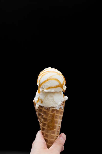 Premium Photo Hand Holding Cone With Flavored Ice Cream