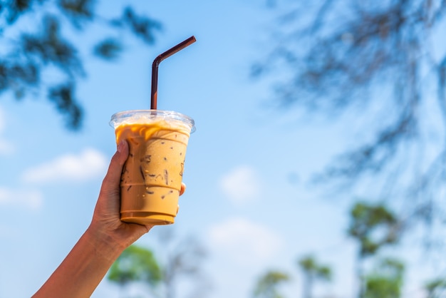 Premium Photo | Hand holding iced latte coffee cup