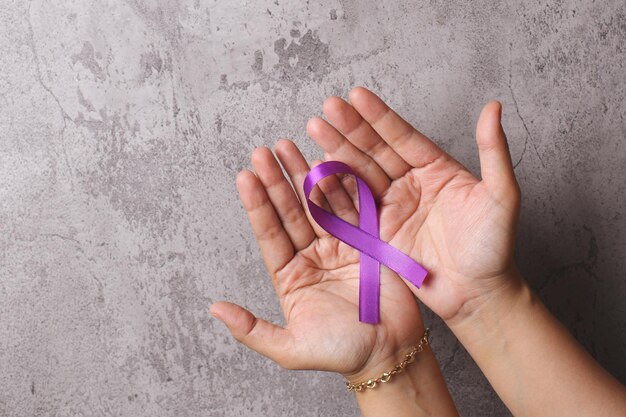 Premium Photo Hand Holding Purple Ribbon For Alzheimers Disease