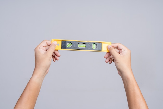 Premium Photo Hand Holding Spirit Level Tool For Building Or Construction