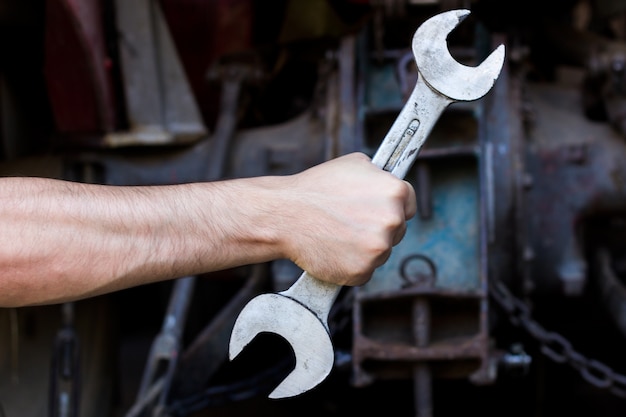 Free Photo | Hand holding wrench on dark background