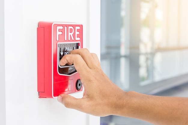 Premium Photo | Hand of man pulling fire alarm switch on the white wall ...