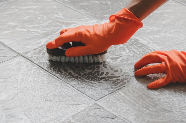 Premium Photo | Hand of man wearing orange rubber gloves is use a hose ...