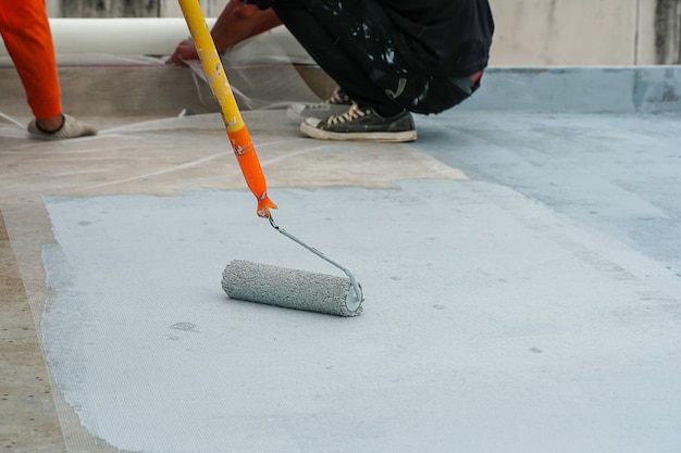 Premium Photo | Hand painted gray flooring with paint rollers for ...