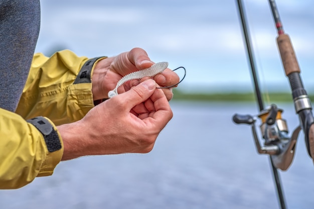 Premium Photo | Hand putting bait on the hook