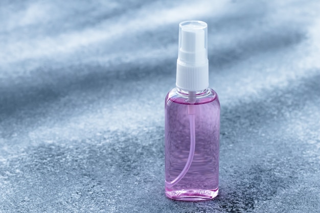 Download Hand sanitizer in bottle, antiseptic spray on a gray ...