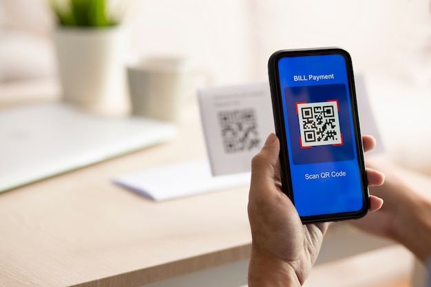 Premium Photo | Hand using a smartphone to scan a qr code