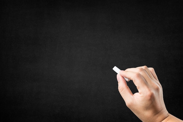 Hand with chalk on a blackboard Free Photo