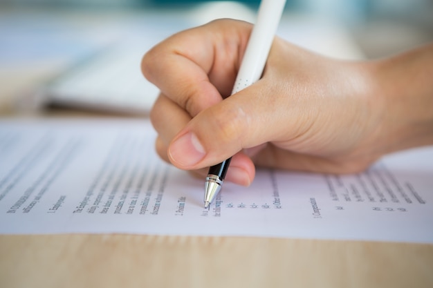 Free Photo Hand With A Pen Writing On A Paper