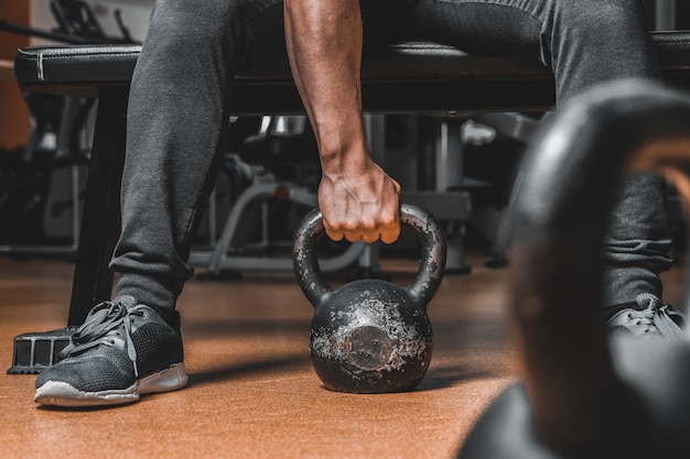 Premium Photo | Hand of a young handsome muscular fitness trainer close ...