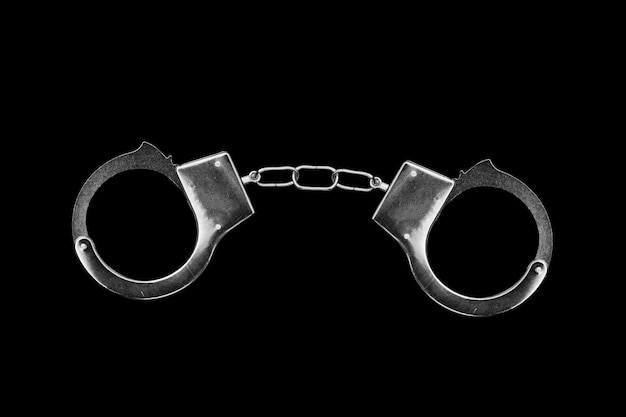 Premium Photo | Handcuffs isolated on a black background. high quality