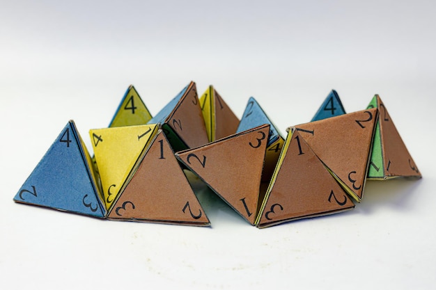 premium-photo-handmade-colored-tetrahedral-numbered-dice-on-paper