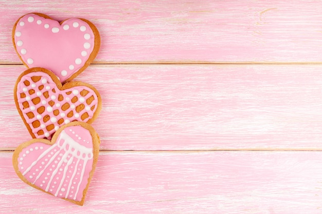 Premium Photo | Handmade heart shaped cookies on pink wooden background ...