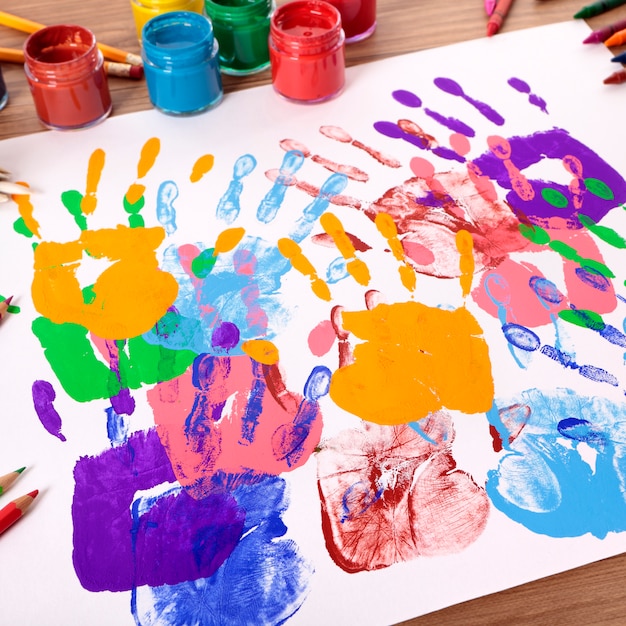 Free Photo | Handprints and art equipment