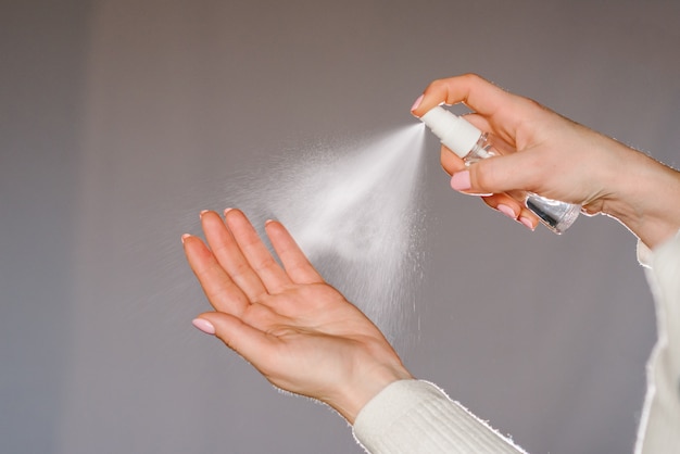 Premium Photo | Hands applying alcohol spray or anti bacteria spray ...