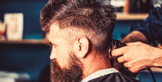 Premium Photo | Hands of barber with hair clipper, close up. haircut ...