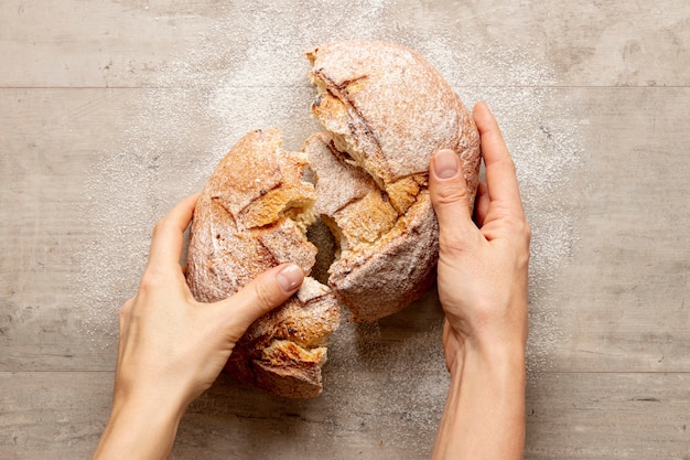 Hands breaking a delicious bread Photo | Free Download