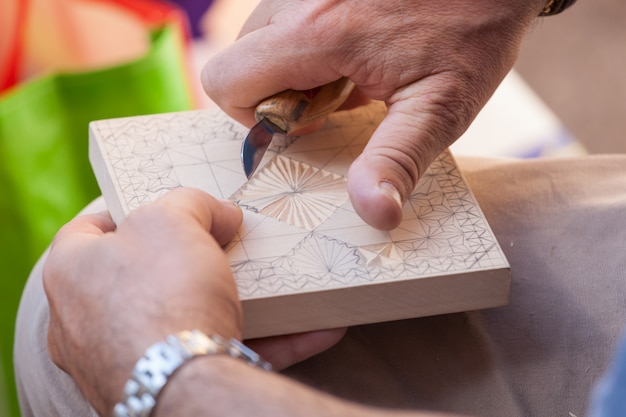 Premium Photo | Hands Of Craftsman While Carving The Wood