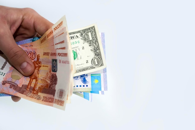 premium-photo-in-the-hands-of-the-currency-of-different-countries-the-ruble-the-dollar-tenge