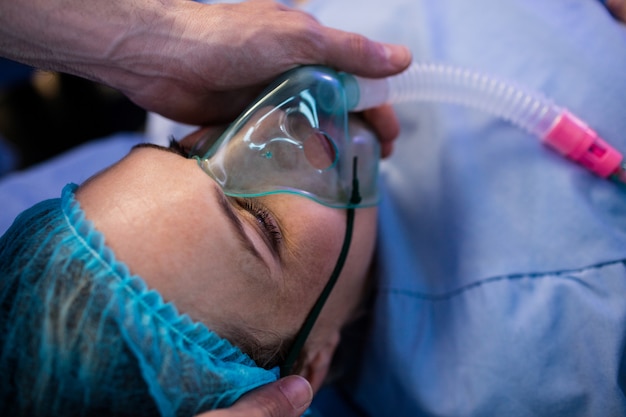 Hands Of Doctor Placing Oxygen Mask On A Pregnant Woman Face Free Photo 