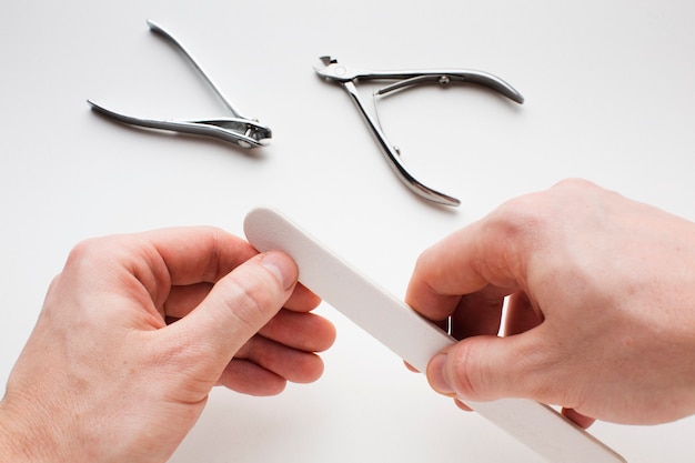 free-photo-hands-filing-own-nails-close-up