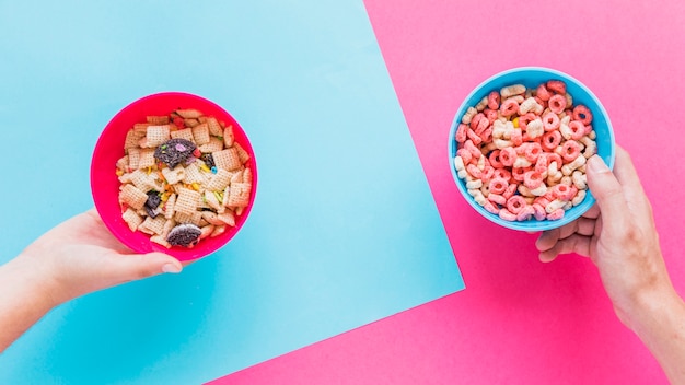 Free Photo | Hands holding bowls with cereals