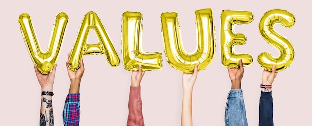 Hands holding values word in balloon letters Premium Photo